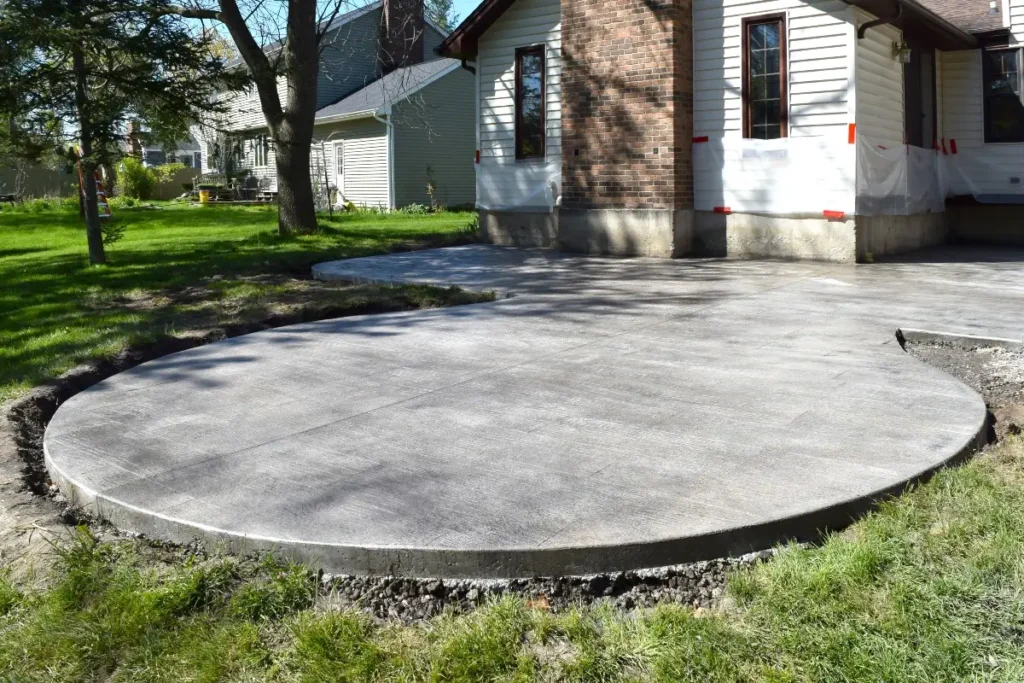 Circular concrete patio in a residential backyard, a durable outdoor space built by Concrete Invercargill.