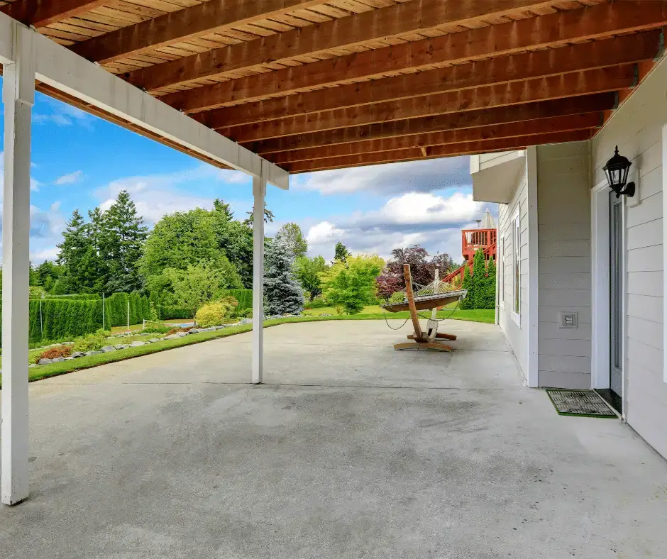 Spacious concrete patio under a wooden pergola, expertly installed by Concrete Invercargill for comfortable outdoor living.